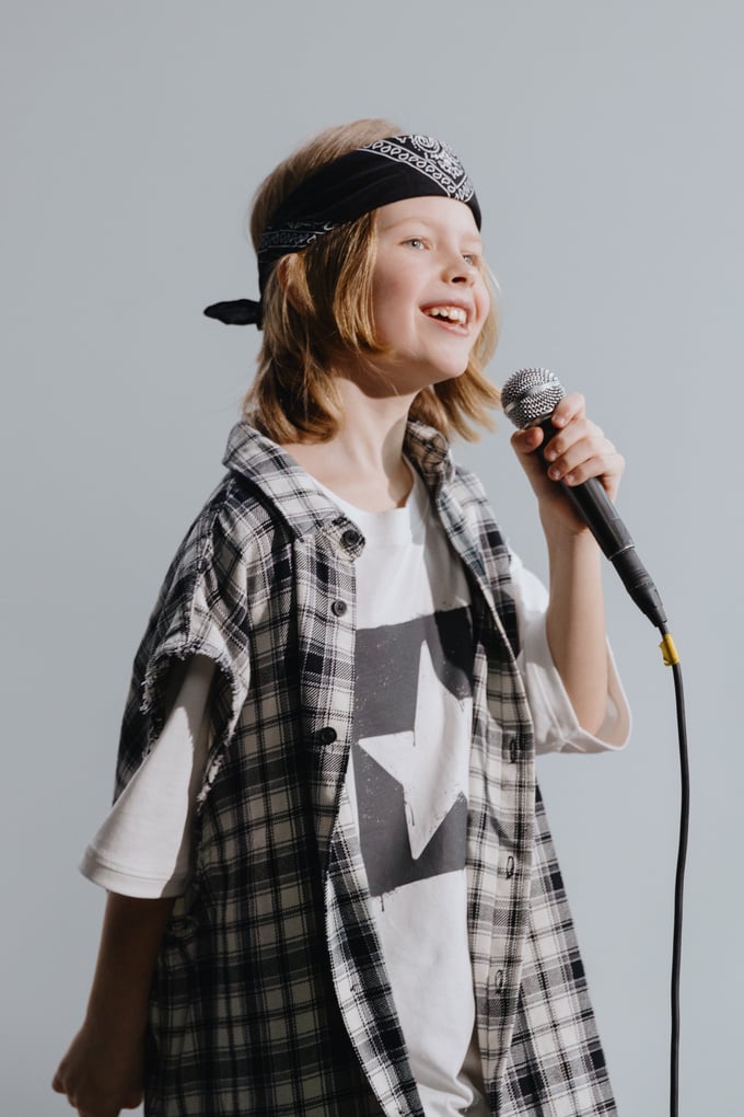 Photograph of a Child with Blond Hair Singing