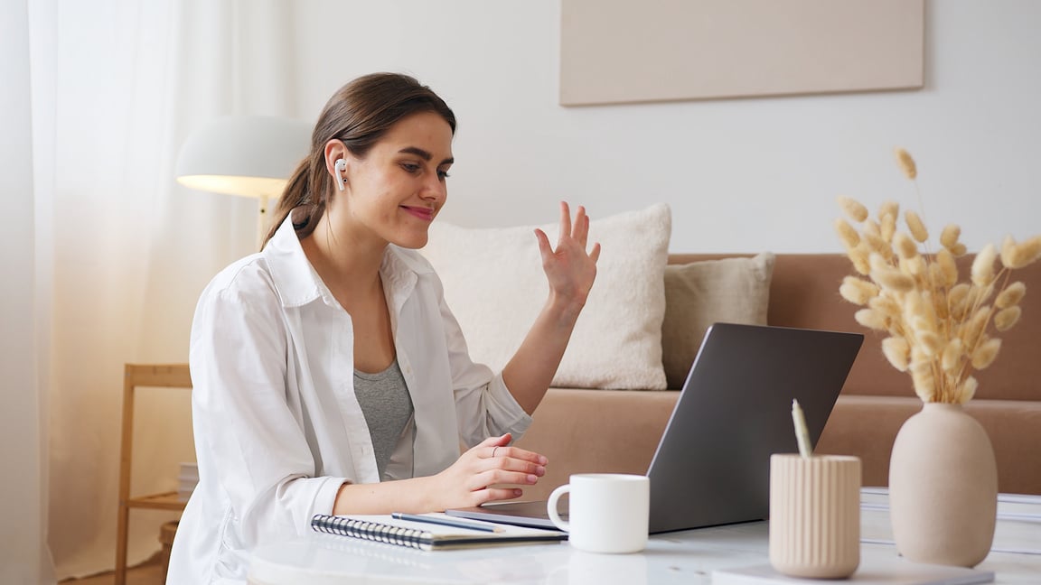 Cheerful woman having video call via laptop